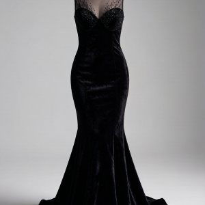 A sculptural mermaid gown in crushed black silk velvet with a dramatic fishtail hem. The illusion sweetheart neckline ad